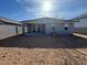 Backyard featuring dirt landscaping, gray block fencing, and a covered patio at 10035 S 23Rd Dr, Phoenix, AZ 85041