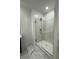Modern glass shower with white tile surround at 10035 S 23Rd Dr, Phoenix, AZ 85041