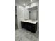 Bathroom featuring a double sink vanity with dark cabinets and light countertop at 10035 S 23Rd Dr, Phoenix, AZ 85041