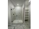 Bathroom featuring a glass enclosed shower and built-in shelving at 10035 S 23Rd Dr, Phoenix, AZ 85041