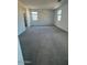 Carpeted bedroom with neutral paint, two windows and walk-in closet at 10035 S 23Rd Dr, Phoenix, AZ 85041