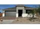 Charming home featuring a gray exterior, two-car garage, and a neatly landscaped front yard at 10035 S 23Rd Dr, Phoenix, AZ 85041