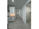 Hallway featuring neutral walls, white doors, wood look flooring, and storage at 10035 S 23Rd Dr, Phoenix, AZ 85041