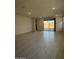 Bright, open living room with tile floors and sliding glass doors to backyard at 10035 S 23Rd Dr, Phoenix, AZ 85041