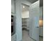 Pantry featuring white shelving, plenty of storage, and gray tile flooring at 10035 S 23Rd Dr, Phoenix, AZ 85041