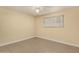 Bedroom features tile flooring, a ceiling fan, and a window for natural light at 10713 N 36Th Ave, Phoenix, AZ 85029