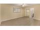 Bedroom features tile flooring, a ceiling fan, and mirrored closet doors at 10713 N 36Th Ave, Phoenix, AZ 85029