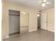 Bedroom showcasing tile flooring, closet, and entry door at 10713 N 36Th Ave, Phoenix, AZ 85029