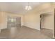 View of the dining room with gray tile flooring and sliding glass door to the rear at 10713 N 36Th Ave, Phoenix, AZ 85029