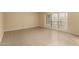 Bright living room featuring neutral paint, tile flooring, and large windows for natural light at 10713 N 36Th Ave, Phoenix, AZ 85029