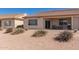 The backyard patio with low-maintenance landscaping and adjacent homes at 10960 E Monte Ave # 131, Mesa, AZ 85209