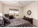 Bedroom with a ceiling fan and a window overlooking a neighborhood with a work space at 10960 E Monte Ave # 131, Mesa, AZ 85209