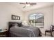 Bedroom with a ceiling fan and a window overlooking a neighborhood at 10960 E Monte Ave # 131, Mesa, AZ 85209