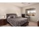 Bright bedroom with a ceiling fan and a window overlooking a neighborhood at 10960 E Monte Ave # 131, Mesa, AZ 85209