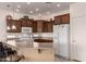 A kitchen featuring wood cabinets, an island with a breakfast bar, and white appliances at 10960 E Monte Ave # 131, Mesa, AZ 85209