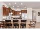 Eat-in kitchen featuring breakfast bar, wood cabinets, and modern appliances at 10960 E Monte Ave # 131, Mesa, AZ 85209