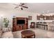 Open living room leading to kitchen with breakfast bar, ceiling fan and natural light at 10960 E Monte Ave # 131, Mesa, AZ 85209
