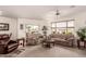 Spacious living room featuring neutral carpet, ceiling fan and sliding glass doors to backyard at 10960 E Monte Ave # 131, Mesa, AZ 85209