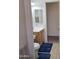 Bright bathroom with wooden cabinet, white sink, toilet and blue rug at 11411 N 91St Ave # 175, Peoria, AZ 85345