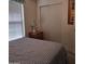 Bedroom features neutral carpet, a large closet, and a wood nightstand with lamp at 11411 N 91St Ave # 175, Peoria, AZ 85345