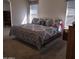 Large bedroom featuring carpet, bright windows, and a king-size bed with patterned bedding at 11411 N 91St Ave # 175, Peoria, AZ 85345