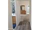 Hallway leading to bathroom and bedroom, featuring a dresser and wood-look flooring at 11411 N 91St Ave # 175, Peoria, AZ 85345