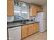 Light and bright kitchen has wooden cabinets, dark countertops, and a stainless steel sink at 11411 N 91St Ave # 175, Peoria, AZ 85345