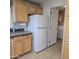 Bright kitchen features wooden cabinets, dark countertops and white refrigerator at 11411 N 91St Ave # 175, Peoria, AZ 85345