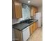 Functional kitchen with stainless steel sink, appliances, ample counter space and wooden cabinets at 11411 N 91St Ave # 175, Peoria, AZ 85345