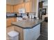Bright kitchen with wooden cabinets, appliances and tiled floor at 11411 N 91St Ave # 175, Peoria, AZ 85345