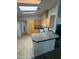 Bright kitchen features a skylight, light wood cabinets, and a functional breakfast bar area at 11411 N 91St Ave # 175, Peoria, AZ 85345