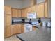 Well-lit kitchen with wooden cabinets, dark countertops and white appliances at 11411 N 91St Ave # 175, Peoria, AZ 85345