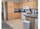 Bright kitchen features wooden cabinets, appliances and a large tiled floor at 11411 N 91St Ave # 175, Peoria, AZ 85345