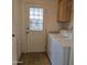 Bright laundry room includes a washer and dryer, with cabinets and access to outside at 11411 N 91St Ave # 175, Peoria, AZ 85345