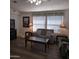 Inviting living room featuring wood laminate flooring, a comfortable sofa, and soft, neutral tones at 11411 N 91St Ave # 175, Peoria, AZ 85345