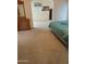 Angle view of the main bedroom leading into an additional area, with carpet and light walls at 11411 N 91St Ave # 175, Peoria, AZ 85345
