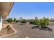 Landscaped backyard with trees and gravel at 13007 W Butterfield Dr, Sun City West, AZ 85375