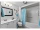 Cozy bathroom featuring a shower-tub combo, toilet, sink, and vanity with cabinet storage at 13007 W Butterfield Dr, Sun City West, AZ 85375