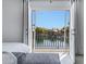 A view of the lake is seen through the open door to the balcony from the main bedroom at 1323 E Whalers Way, Tempe, AZ 85283