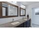 Modern bathroom with double sinks, framed mirrors, and subway tile backsplash at 1323 E Whalers Way, Tempe, AZ 85283