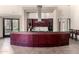 Elegant bar area with rich wood cabinetry, glass countertop, and modern appliances at 14250 W Wigwam Blvd # 812, Litchfield Park, AZ 85340