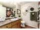 Bathroom offering sink with cabinet storage, updated hardware, and framed mirror at 14250 W Wigwam Blvd # 812, Litchfield Park, AZ 85340
