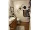Well-lit bathroom with wood floors and decorative wall hangings creating a relaxing ambiance at 14250 W Wigwam Blvd # 812, Litchfield Park, AZ 85340