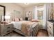 Cozy bedroom with a large bed, bedside tables, soft lighting, and a patterned accent blanket at 14250 W Wigwam Blvd # 812, Litchfield Park, AZ 85340