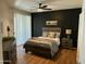 Spacious bedroom with a dark accent wall, ceiling fan, and large window with blinds at 14250 W Wigwam Blvd # 812, Litchfield Park, AZ 85340