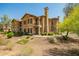 Stunning two-story townhouse with a desert landscape, a chimney, and a small upper balcony at 14250 W Wigwam Blvd # 812, Litchfield Park, AZ 85340