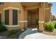Inviting front entryway featuring a covered porch, a stylish door, and a desert landscape at 14250 W Wigwam Blvd # 812, Litchfield Park, AZ 85340