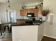 Open kitchen featuring oak cabinets, black appliances, and a breakfast bar with counter seating at 14250 W Wigwam Blvd # 812, Litchfield Park, AZ 85340