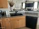 Well-lit kitchen with stainless steel appliances, dark countertops, and views into the living room at 14250 W Wigwam Blvd # 812, Litchfield Park, AZ 85340