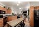 Bright, open kitchen featuring modern appliances and an island, with a view of the dining and living areas at 14250 W Wigwam Blvd # 812, Litchfield Park, AZ 85340